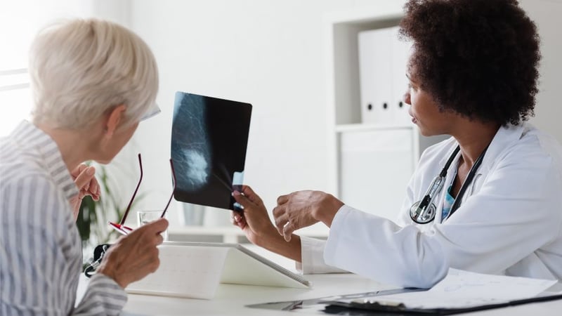 woman discussing breast scan with oncologist after metastatic breast cancer diagnosis