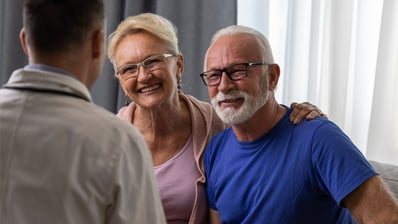 elderly man with wife discussing prostate cancer treatment options